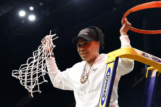 South Carolina head coach Dawn Staley cuts down the net after defeating Duke to advance to the Final Four on Sunday, March 30, 2025, in Birmingham, Ala. 