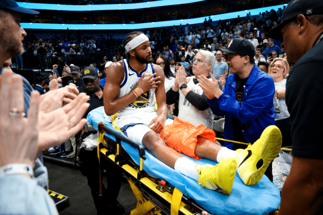 Mar 23, 2026; Dallas, Texas, USA; Golden State Warriors guard Moses Moody (4) waves to fans while leaving the court on a stretcher during overtime against the Dallas Mavericks at American Airlines Center. Mandatory Credit: Kevin Jairaj-Imagn Images