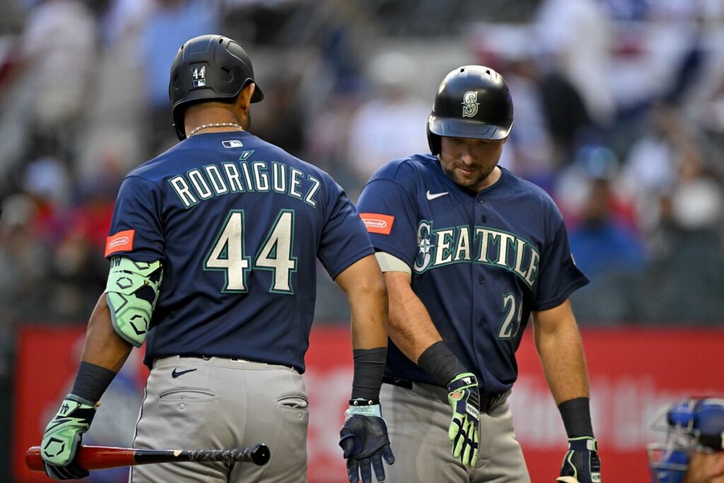Julio Rodriguez and Cal Raleigh celebrate a home run for the Mariners.