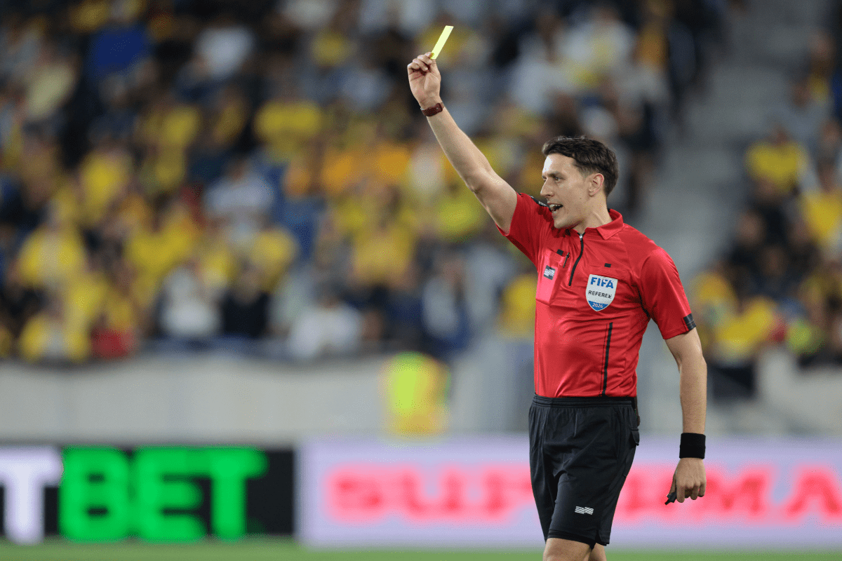 May 30, 2026; Harrison, New Jersey, USA; Adressing soccer fouls, Referee Pierre-Luc Lauziere shows a yellow card during the first half of an international friendly between Ecuador and Saudi Arabia at Sports Illustrated Stadium. Mandatory Credit: Vincent Carchietta-Imagn Images