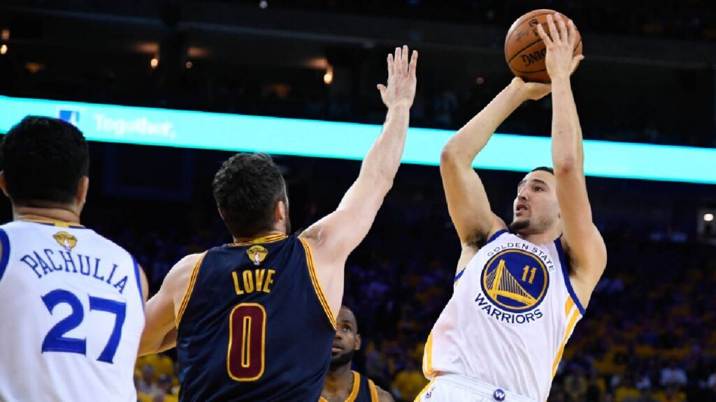 Golden State Warriors guard Klay Thompson (11) shoots over Cleveland Cavaliers forward Kevin Love (0) in the second half of the 2017 NBA Finals at Oracle Arena.