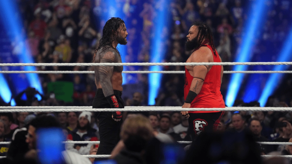roman reigns standing in a wwe ring