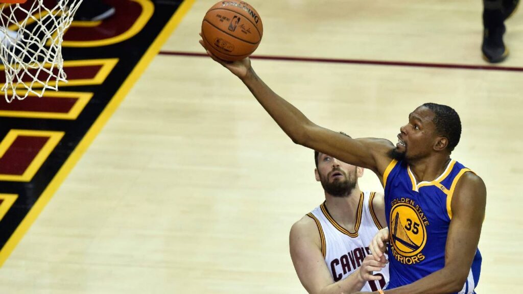 Golden State Warriors forward Kevin Durant (35) shoots the ball against Cleveland Cavaliers forward Kevin Love (0) during the third quarter in game four of the Finals for the 2017 NBA Playoffs at Quicken Loans Arena.