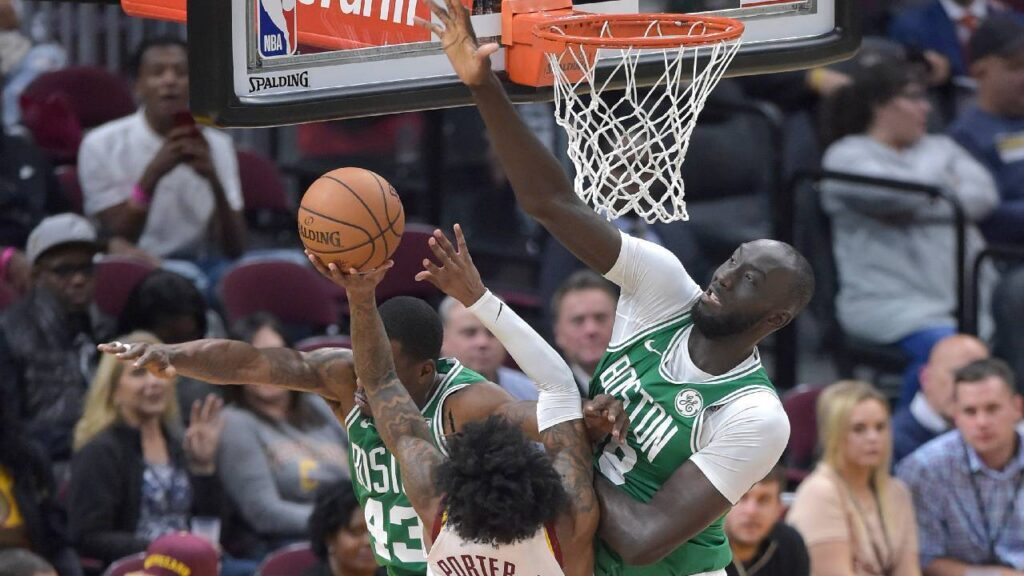 Cleveland Cavaliers guard Kevin Porter Jr. (4) drives to the basket against Boston Celtics guard Javonte Green (43) and center Tacko Fall (99) in the fourth quarter at Rocket Mortgage FieldHouse.