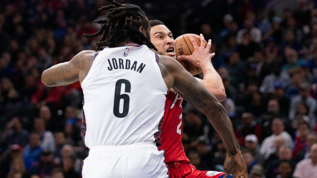 Philadelphia 76ers guard Ben Simmons (25) drives against Brooklyn Nets center DeAndre Jordan (6) during the second quarter at Wells Fargo Center. Jordan suffered an apparent injury to his hand on the play.