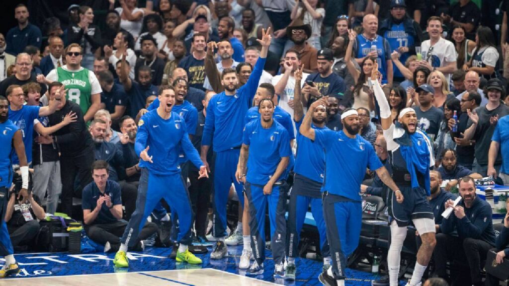 The Dallas Mavericks fans and team bench celebrate during the game between the Dallas Mavericks and the Boston Celtics in game four of the 2024 NBA Finals at American Airlines Center.