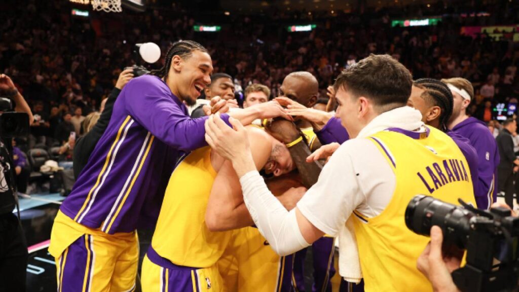 Los Angeles Lakers team celebrates Luka Doncic (77) after 60 point game against the Miami Heat at Kaseya Center.
