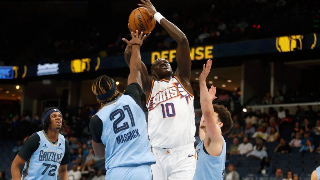 Khaman Maluach shoots between Memphis defenders as the Phoenix Suns Mark Williams Injury opens a larger opportunity at center.