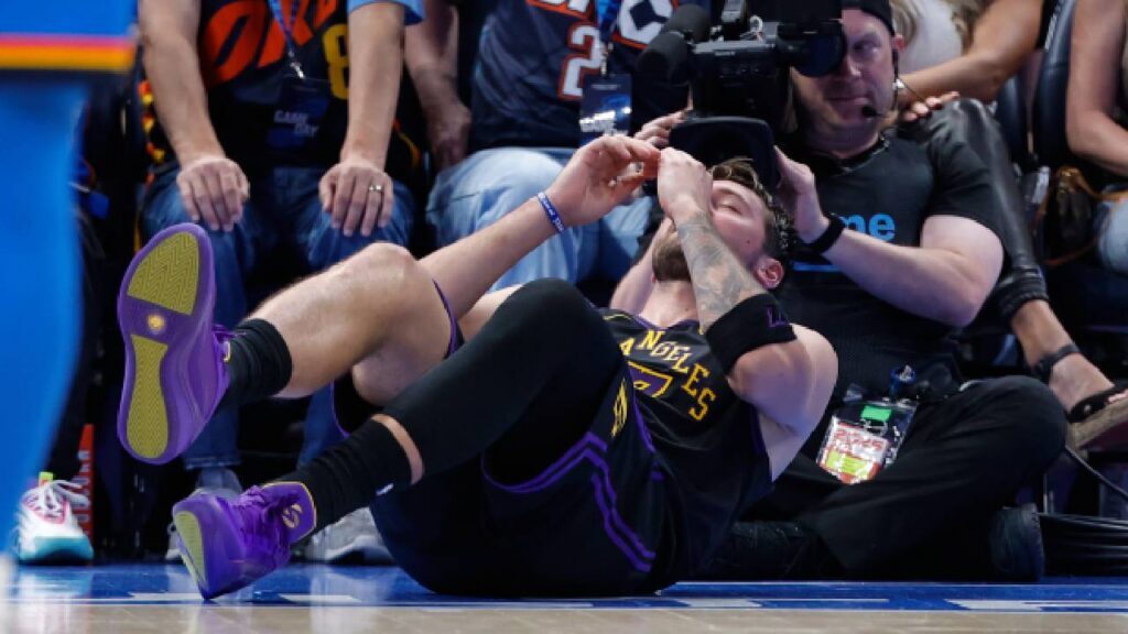 Los Angeles Lakers guard Luka Doncic (77) falls to the court after an injury against the Oklahoma City Thunder during the second half at Paycom Center.