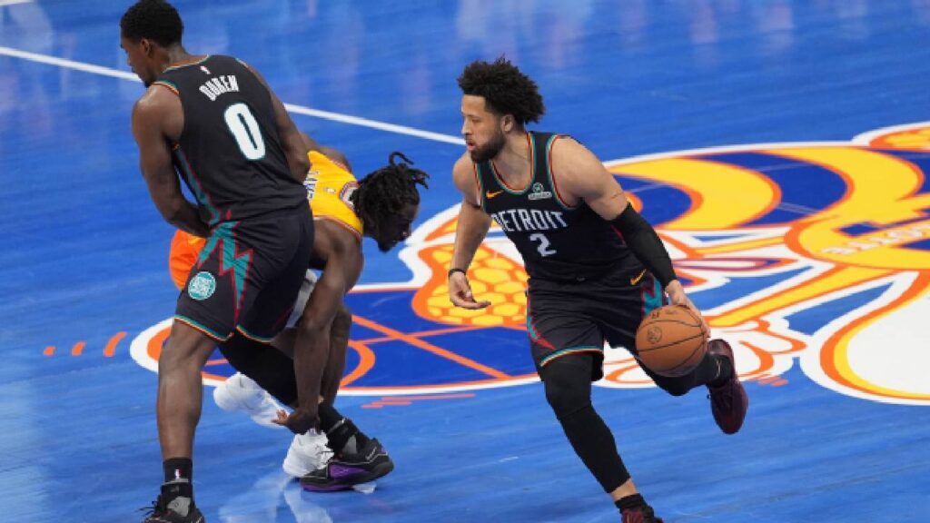 Cade Cunningham dribbles while Jalen Duren blocks Sion James during a 2026 Pistons game amid Jalen Duren Contract Negotiations