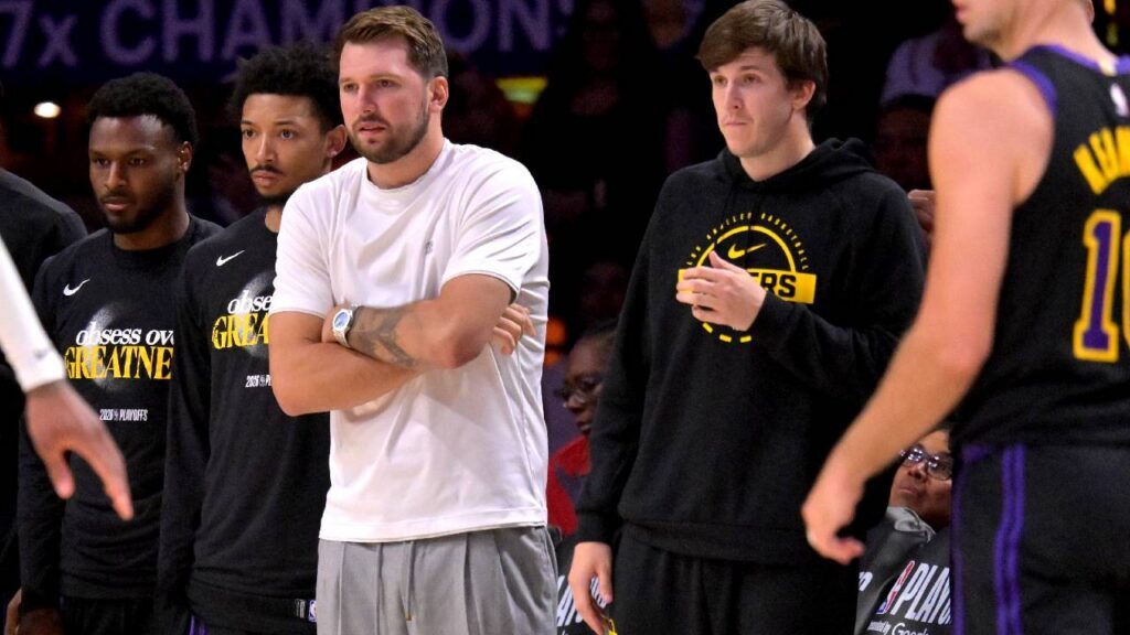 Los Angeles Lakers guard Luka Doncic (77) and guard Austin Reaves (15) look on from the bench during the second half of game two of the first round of the 2026 NBA Playoffs against the Houston Rockets at Crypto.com Arena.