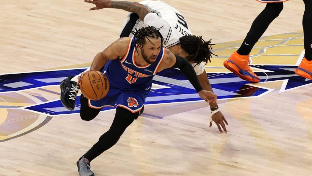 New York Knicks guard Jalen Brunson (11) dribbles the ball past San Antonio Spurs guard Stephon Castle (5) in the second half during game two of the 2026 NBA Finals at Frost Bank Center.