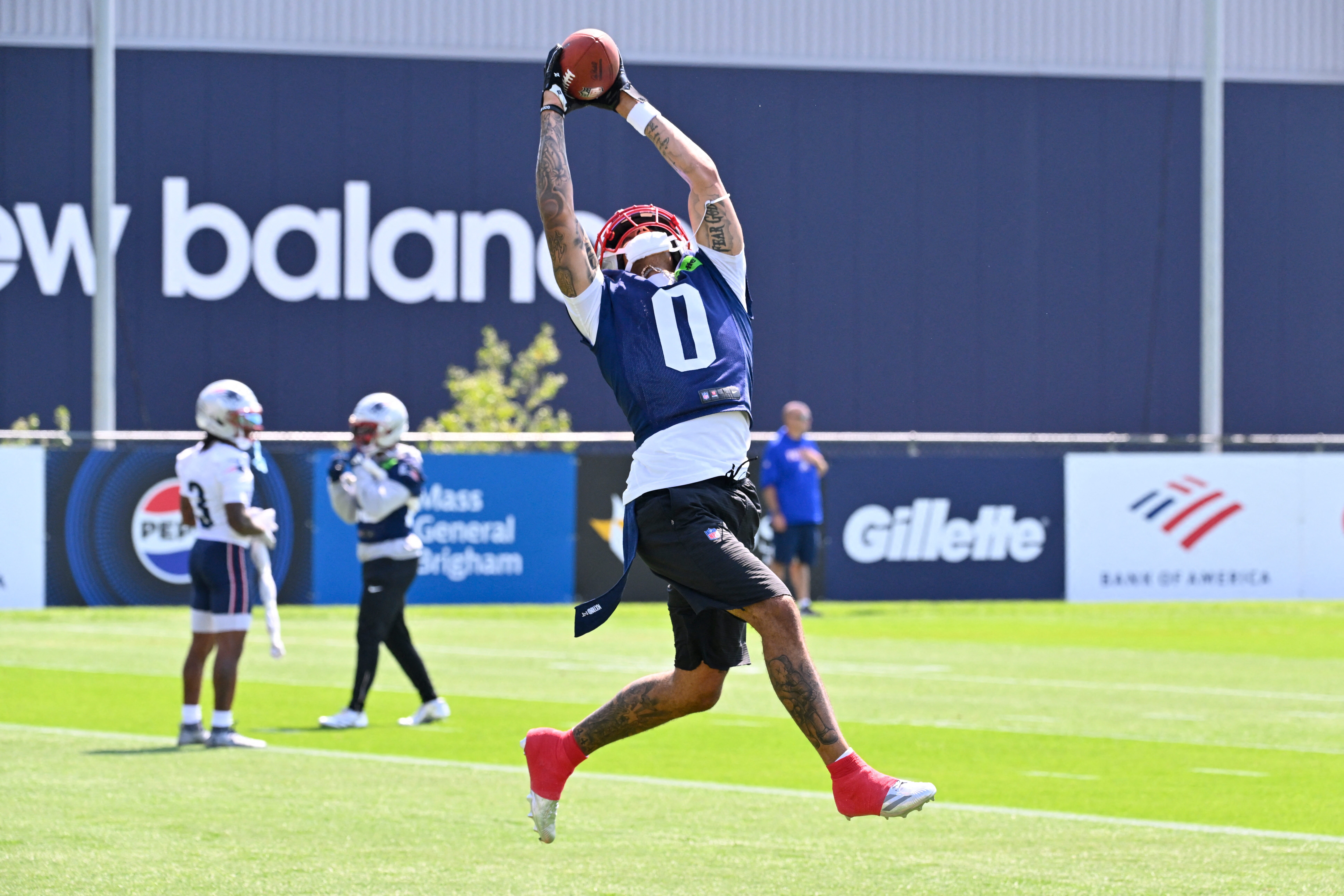 Jul 25, 2026; Foxborough, MA, USA; New England Patriots cornerback Christian Gonzalez (0) makes a catch at training camp at Gillette Stadium. The Christian Gonzalez contract drama threatens to spill into the new NFL season. Mandatory Credit: Eric Canha-Imagn Images