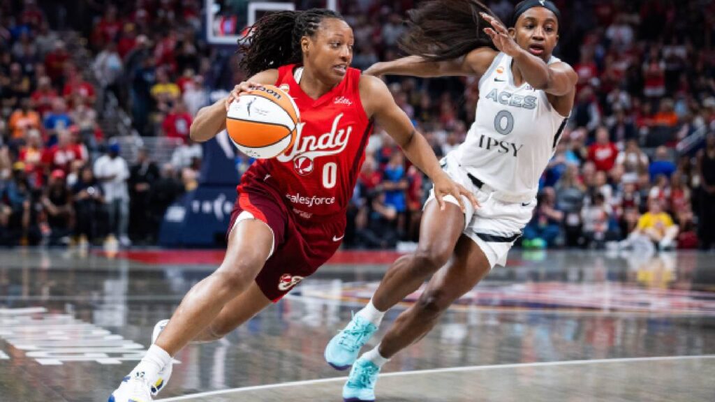 Kelsey Mitchell drives against Las Vegas Aces guard Jackie Young during the Fever’s Aug. 6, 2026, game, as Caitlin Clark and Indiana prepare for the playoffs.