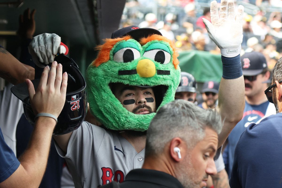 Aug 16, 2026; Pittsburgh, Pennsylvania, USA; Boston Red Sox catcher Connor Wong (12) celebrates his three run home run while wearing a Wally the Green Monster head in the dugout against the Pittsburgh Pirates during the fifth inning at PNC Park. Mandatory Credit: Charles LeClaire-Imagn Images