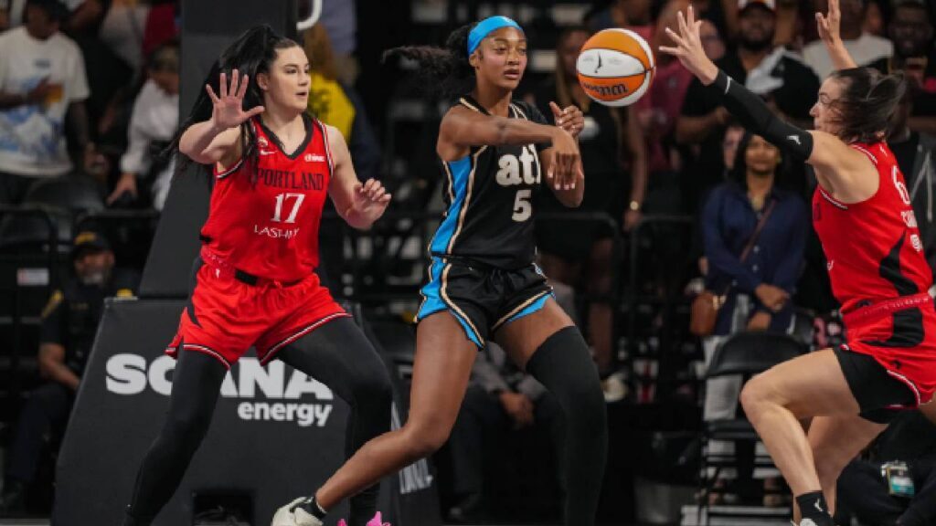 Atlanta Dream forward Angel Reese (5) passes in front of Portland Fire Portland Fire center Megan DiLeo (17) during the first half at Gateway Center Arena at College Park.
