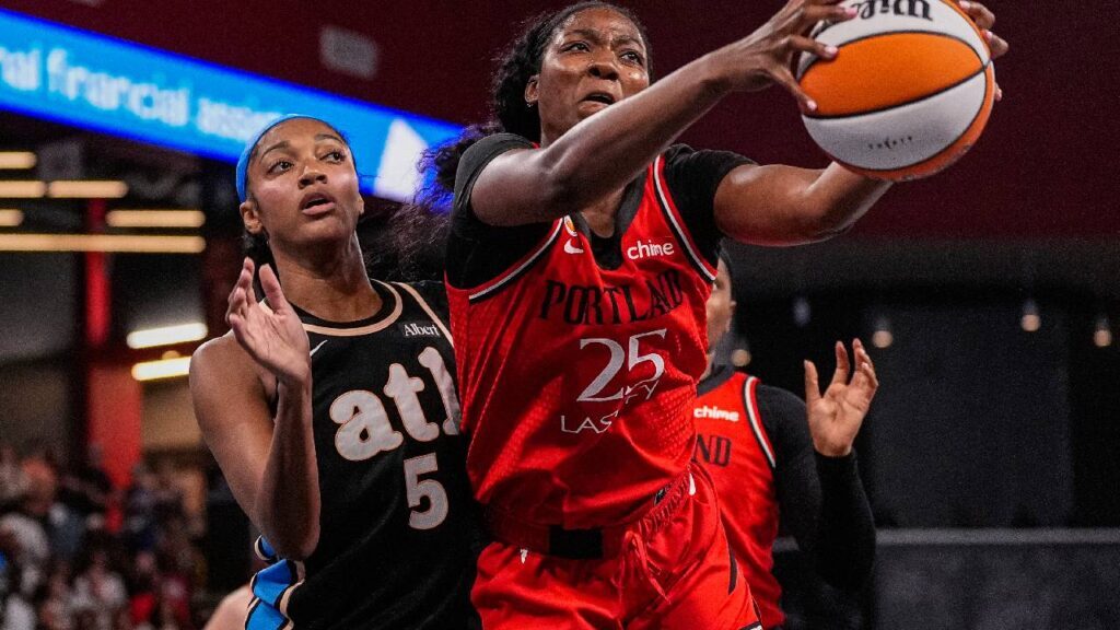 Portland Fire center Serah Williams (25) and Atlanta Dream forward Angel Reese (5) fight for a rebound during the second half at Gateway Center Arena at College Park.