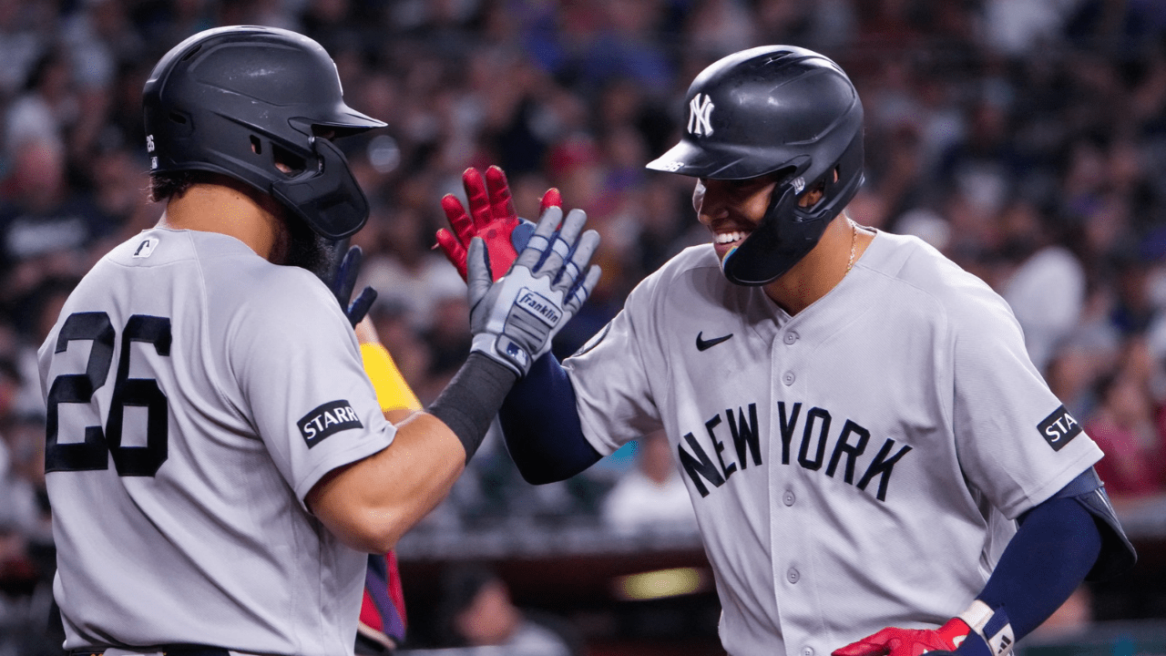 Sep 20, 2026; Phoenix, Arizona, USA; New York Yankees, (MLB playoff contender) shortstop George Lombard Jr. (96) celebrates with first baseman Luis Garcia Jr. (26) during the third inning at Chase Field during the game between Arizona Diamondbacks and the New York Yankees. Mandatory Credit: Arianna Grainey-Imagn Images