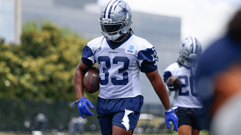 Javonte Williams holding a ball at practice
