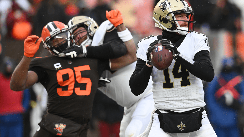 Dec 24, 2022; Cleveland, Ohio, USA; New Orleans Saints quarterback Andy Dalton (14) prepares to throw a pass as Cleveland Browns defensive end Myles Garrett (95) rushes during the second half at FirstEnergy Stadium. Mandatory Credit: Ken Blaze-USA TODAY Sports