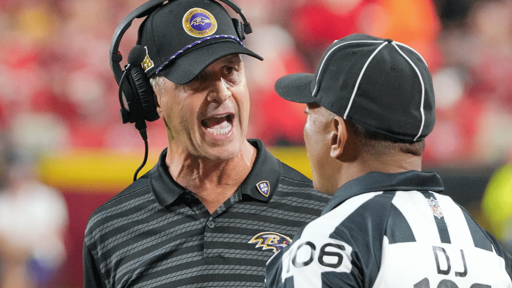 Sep 5, 2024; Kansas City, Missouri, USA; Baltimore Ravens head coach John Harbough talks with down judge Patrick Holt (106) against the Kansas City Chiefs during the game at GEHA Field at Arrowhead Stadium. Mandatory Credit: Denny Medley-Imagn Images