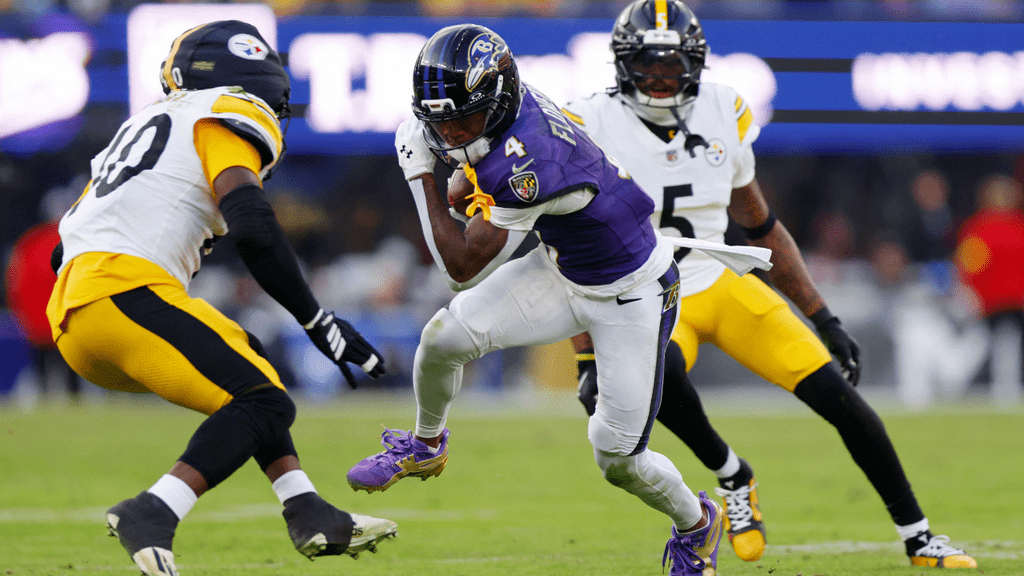 Dec 7, 2025; Baltimore, Maryland, USA; Baltimore Ravens wide receiver Zay Flowers (4) runs with the ball after making a catch against the Pittsburgh Steelers during the second half at M&T Bank Stadium. Mandatory Credit: Peter Casey-Imagn Images. John Harbaugh.