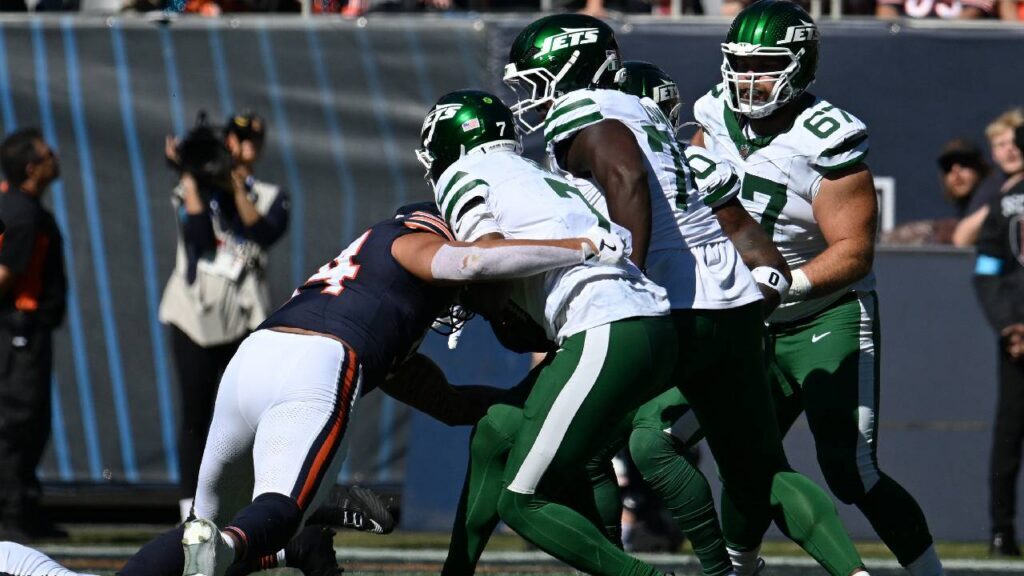 Chicago Bears defensive lineman Austin Booker sacks New York Jets quarterback Geno Smith as the Chicago Bears ground game helped control the Week 4 victory.