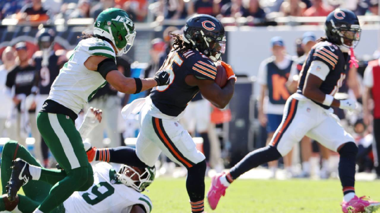 Chicago Bears ground game leader Kyle Monangai runs with the football against New York Jets safety Dane Belton during the third quarter at Soldier Field.