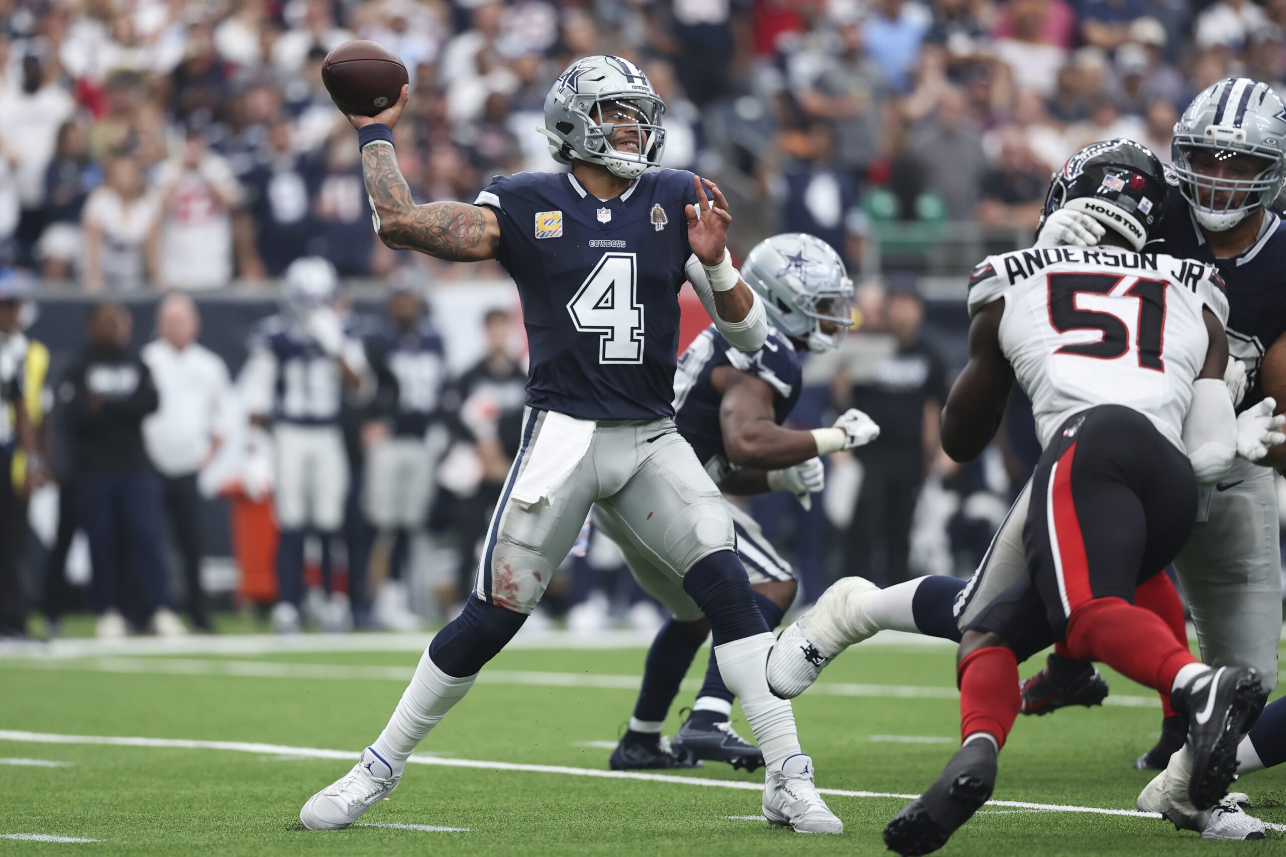 Dallas Cowboys quarterback Dak Prescott prepares to fire a pass downfield versus the Houston Texans.