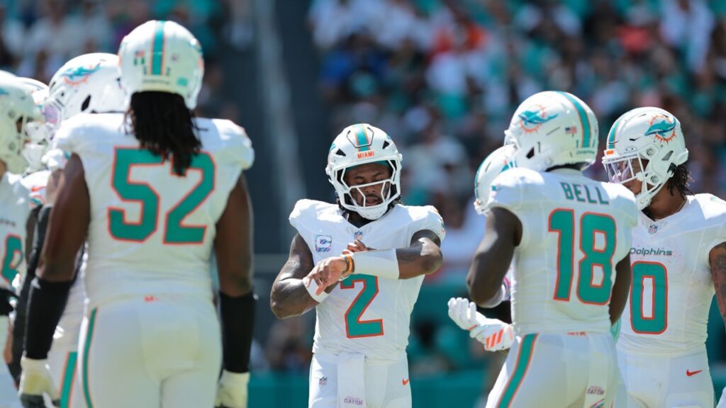 “Miami Dolphins players gather during a game against the Cincinnati Bengals ahead of the Miami Dolphins bye week.”