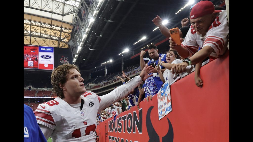 JJ McCarthy greets supporters after leading the Giants to a win over the Texans