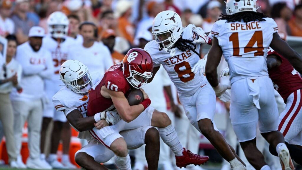 Sooners' QB John Mateer taken down for a loss against Texas.
