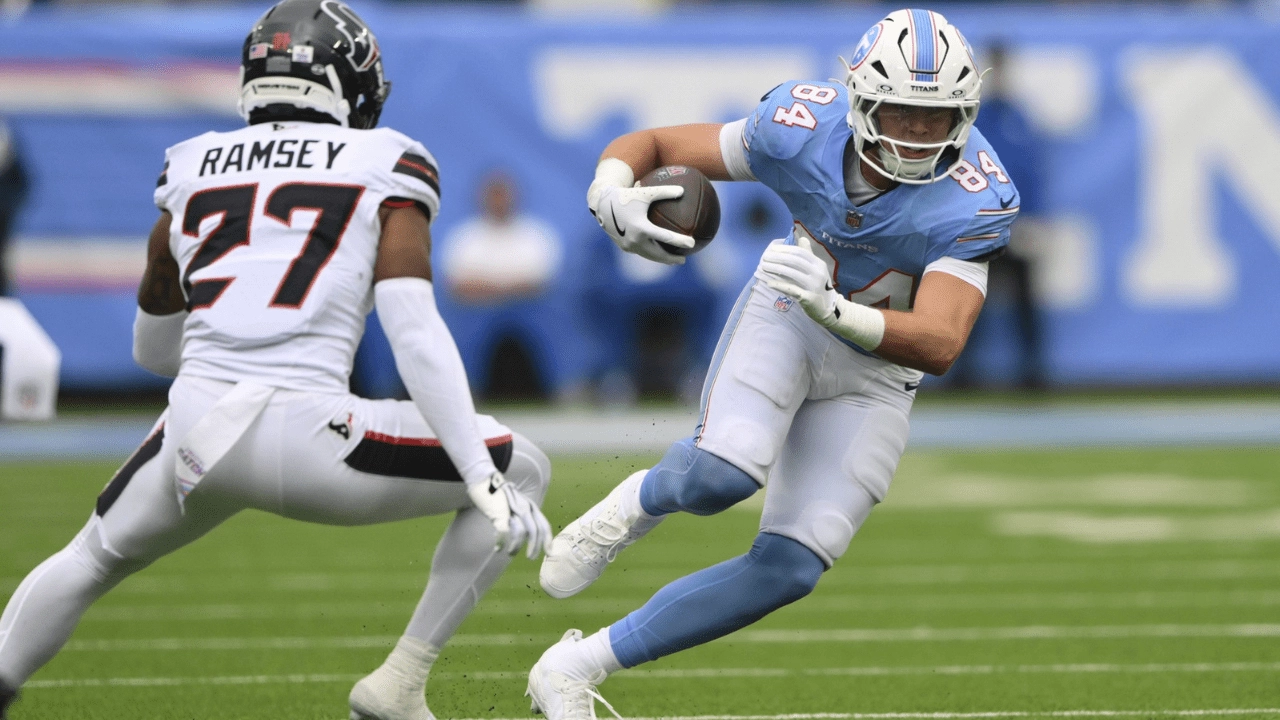Oct 11, 2026; Nashville, Tennessee, USA; Tennessee Titans tight end Gunnar Helm (84) runs the ball against Houston Texans safety Kamari Ramsey (27) during the fourth quarter at Nissan Stadium. Mandatory Credit: Steve Roberts-Imagn Images