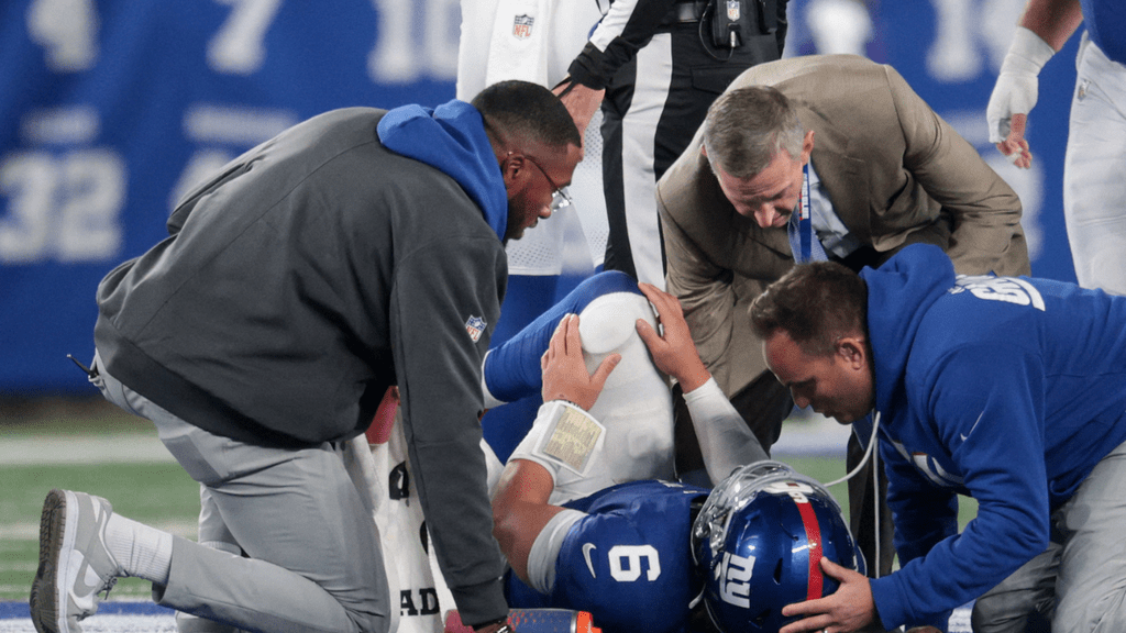 Oct 9, 2025; East Rutherford, New Jersey, USA; Trainers check on New York Giants quarterback Jaxson Dart (6) after an injury against the Philadelphia Eagles during the third quarter of the game at MetLife Stadium. Mandatory Credit: Vincent Carchietta-Imagn Images. NFL.