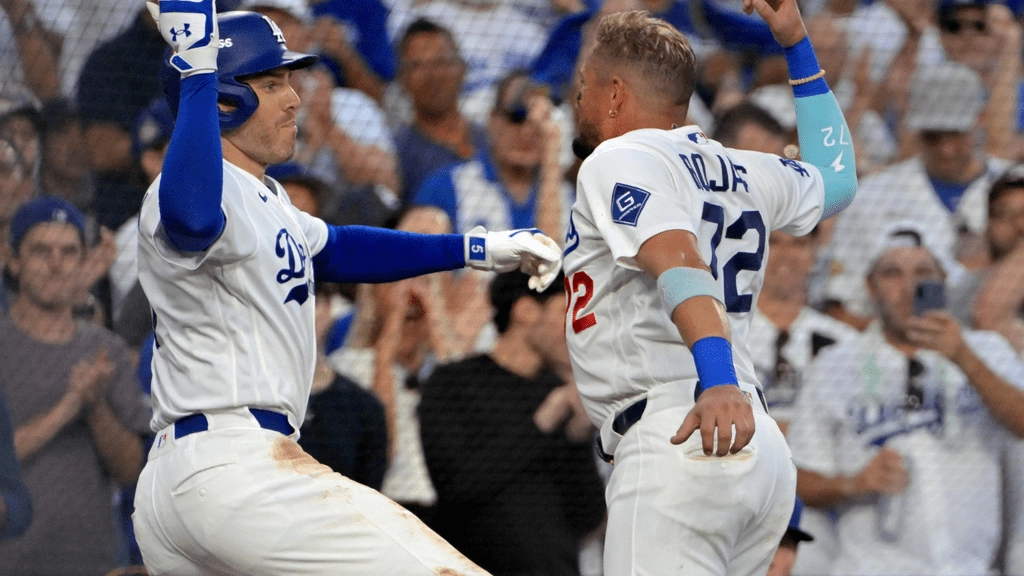 Oct 4, 2026; Los Angeles, California, USA; Los Angeles Dodgers first baseman Freddie Freeman (5) celebrates with second baseman Miguel Rojas (72) after hitting a home run during the fourth inning against the Atlanta Braves in game two of the NLDS for the 2026 MLB Playoffs at Uniqlo Field at Dodger Stadium. Mandatory Credit: Jayne Kamin-Oncea-Imagn Images