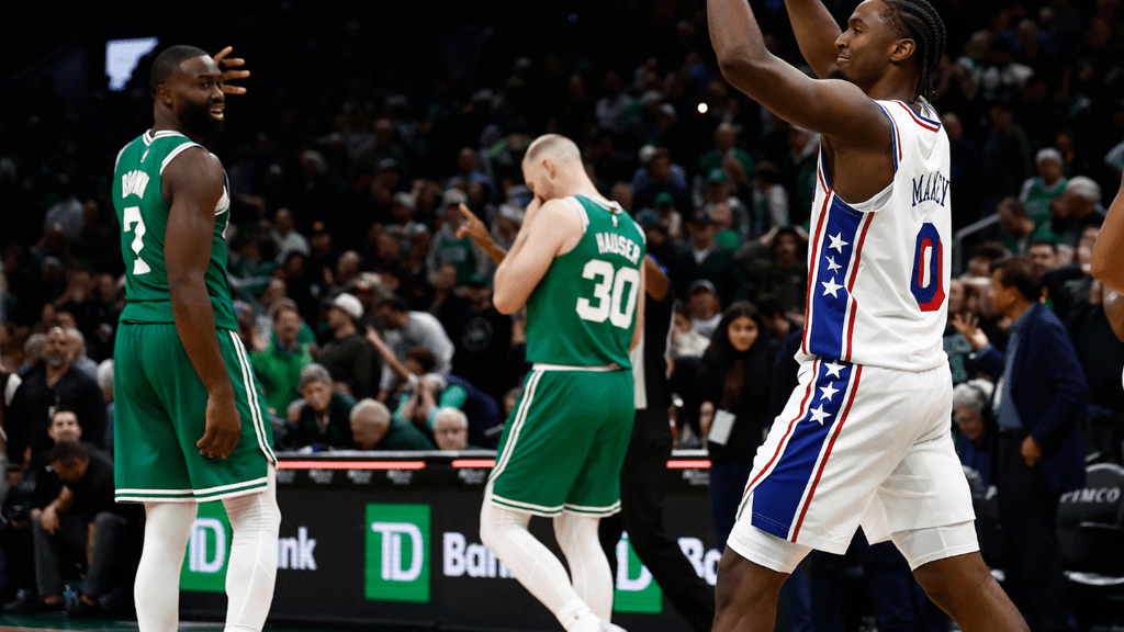 Oct 22, 2025; Boston, Massachusetts, USA; As Boston Celtics forward Sam Hauser (30) and guard Jaylen Brown (7) walk towards their bench, Philadelphia 76ers guard Tyrese Maxey (0) celebrates after the Celtics were unable to make a last second shot during the Sixers 117-116 win at TD Garden. Mandatory Credit: Winslow Townson-Imagn Images. NBA.