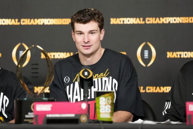 Fernando Mendoza sitting at the podium after winning the national championship.