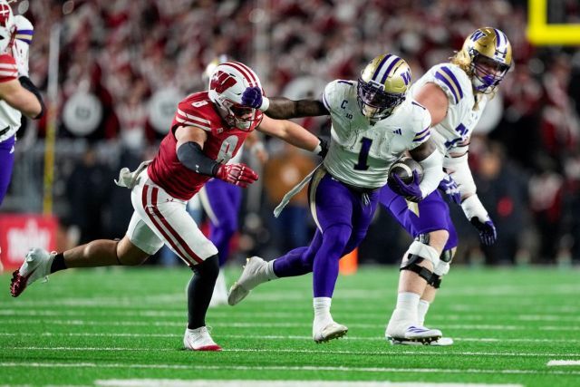 Jonah Coleman breaking a tackle against Wisconsin