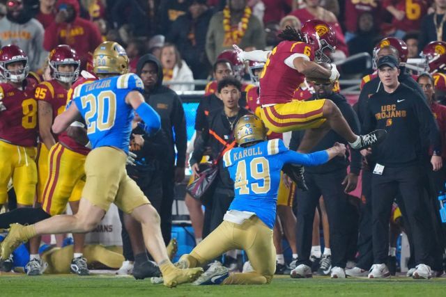 Makai Lemon hurdling a defender against UCLA.