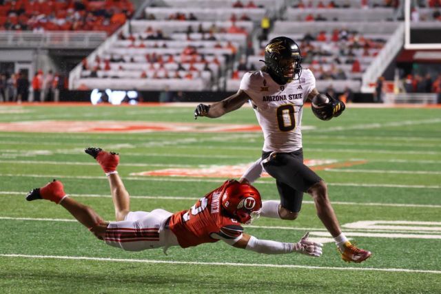 Jordyn Tyson escaping a defender as he runs into the endzone against Utah