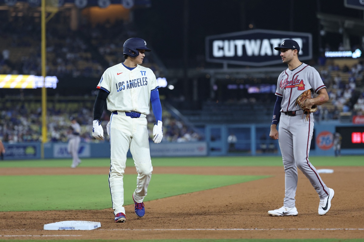 NL MVP candidates Shohei Ohtani and Matt Olson converse at first base.
