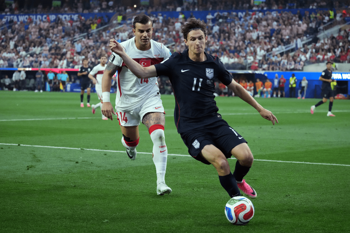 Jun 25, 2026; Inglewood, California, USA; USMNT midfielder Brenden Aaronson (11) and Turkey defender Abdülkerim Bardakcı (14) battle for the ball during a Group D match in the 2026 FIFA World Cup at Los Angeles Stadium. Mandatory Credit: Kirby Lee-Imagn Images