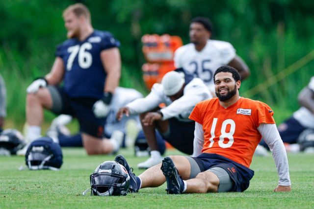 Caleb Williams resting on the field