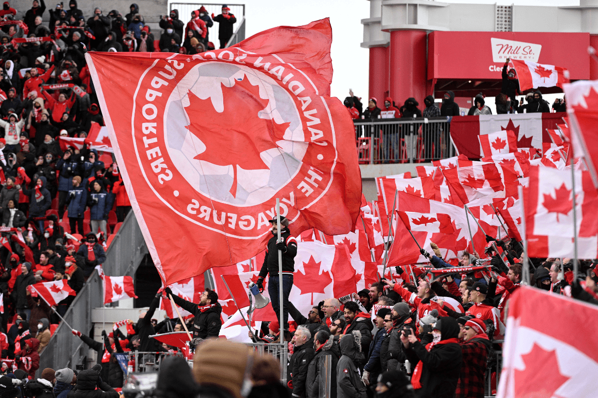 Mar 27, 2022; Toronto, Ontario, CAN; Canada supporters fly flags before kickoff against Jamaica in a FIFA World Cup qualifying soccer match at BMO Field. Mandatory Credit: Dan Hamilton-USA TODAY Sports