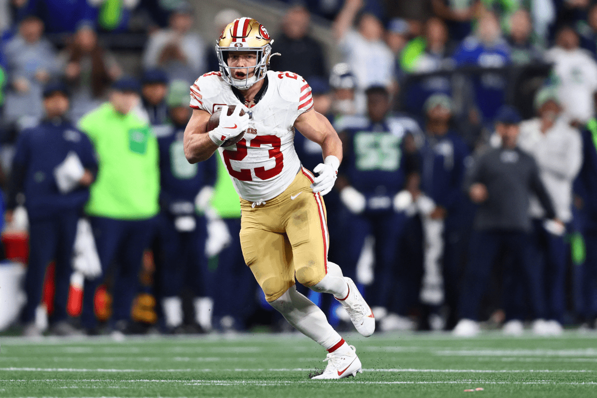 Jan 17, 2026; Seattle, WA, USA; San Francisco 49ers running back Christian McCaffrey (23) runs after the catch against the Seattle Seahawks during the first half in an NFC Divisional Round game at Lumen Field. Mandatory Credit: Kevin Ng-Imagn Images. McCaffrey is rated is a potential fantasy football bust in this years draft accoridng to Stadium Rantl.