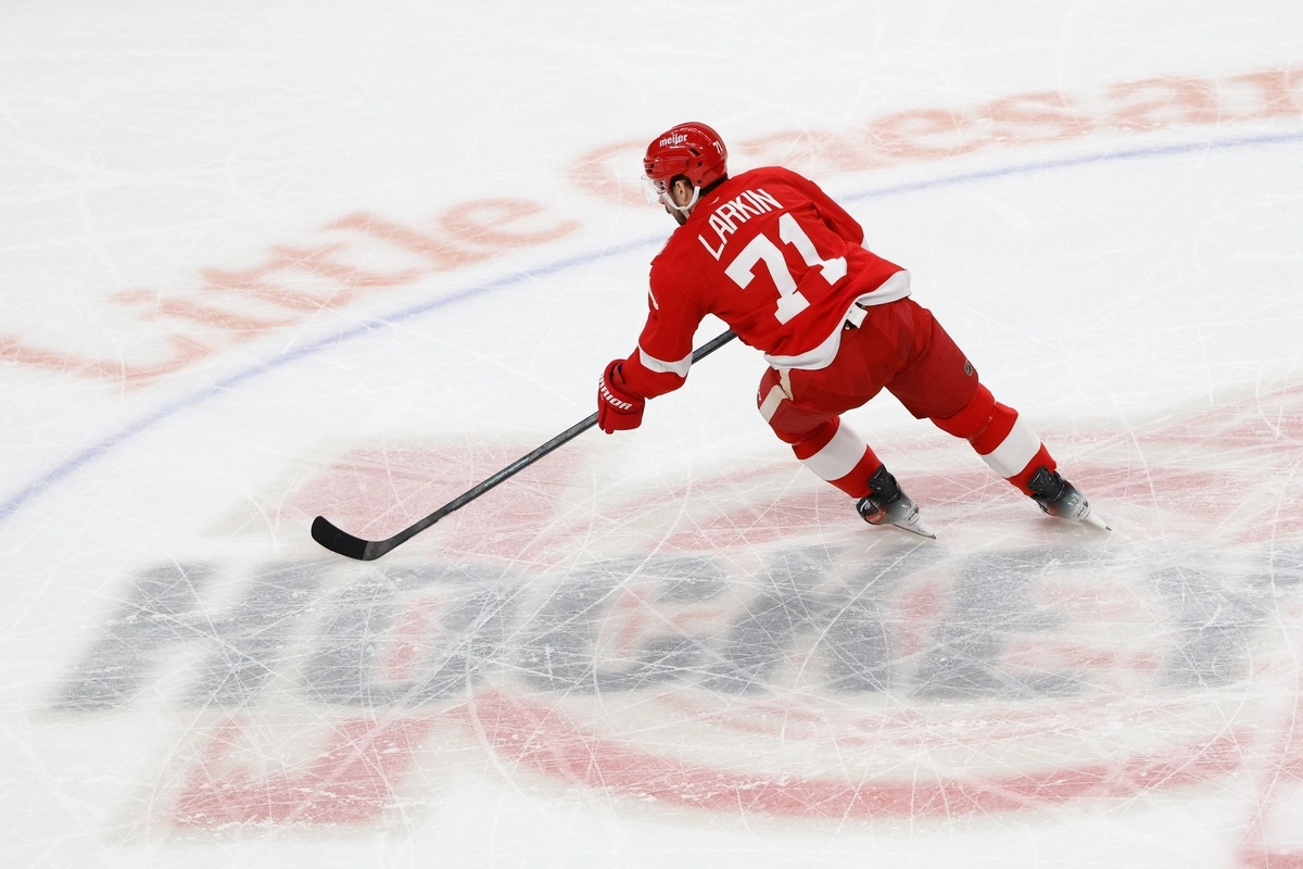 Dylan Larkin skates with the puck.