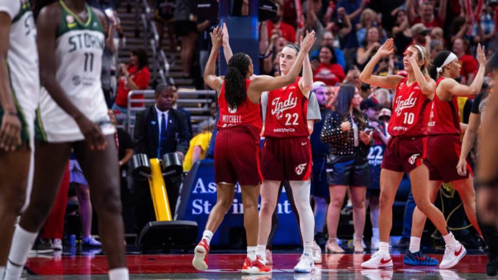Indiana Fever guard Caitlin Clark (22) celebrates with guard Kelsey Mitchell (0) after defeating the Seattle Storm in the second half at Gainbridge Fieldhouse.