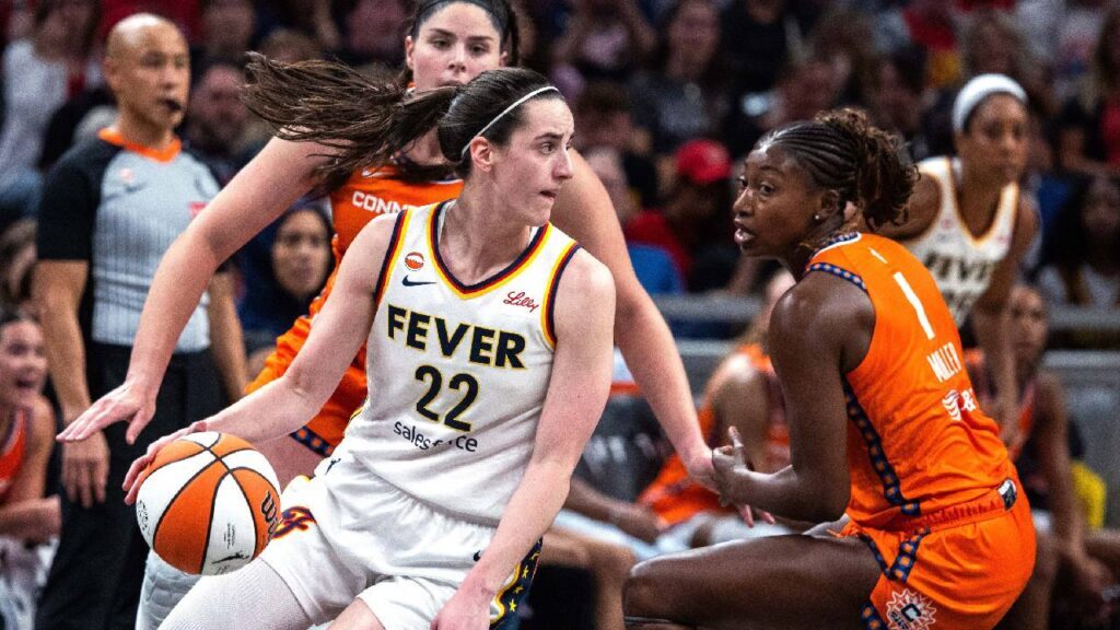Indiana Fever guard Caitlin Clark (22) dribbles the ball while Connecticut Sun forward Diamond Miller (1) defends in the second half at Gainbridge Fieldhouse. 