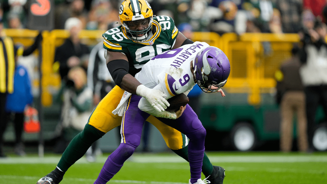 Nov 23, 2025; Green Bay, Wisconsin, USA; Minnesota Vikings quarterback J.J. McCarthy (9) is sacked by. Green Bay Packers defensive tackle Devonte Wyatt (95) during the second half at Lambeau Field. Mandatory Credit: Kayla Wolf-Imagn Images