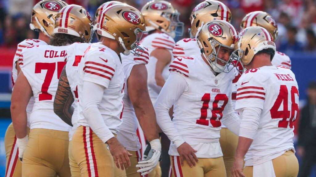 San Francisco 49ers place kicker Eddy Pineiro (18) reacts with long snapper Jon Weeks (46) after kicking a field goal against the New York Giants during the first half at MetLife Stadium.
